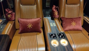 Close-up of twin cinema recliners with in-arm control panel and pillows